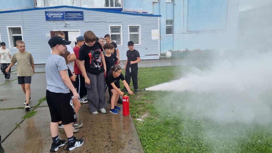 ребята учатся пользоваться порошковым огнетушителем