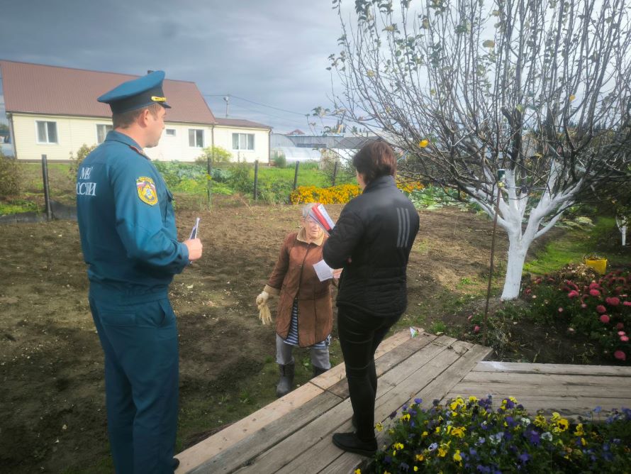 сотрудники пожарной охраны вручают памятки жителям